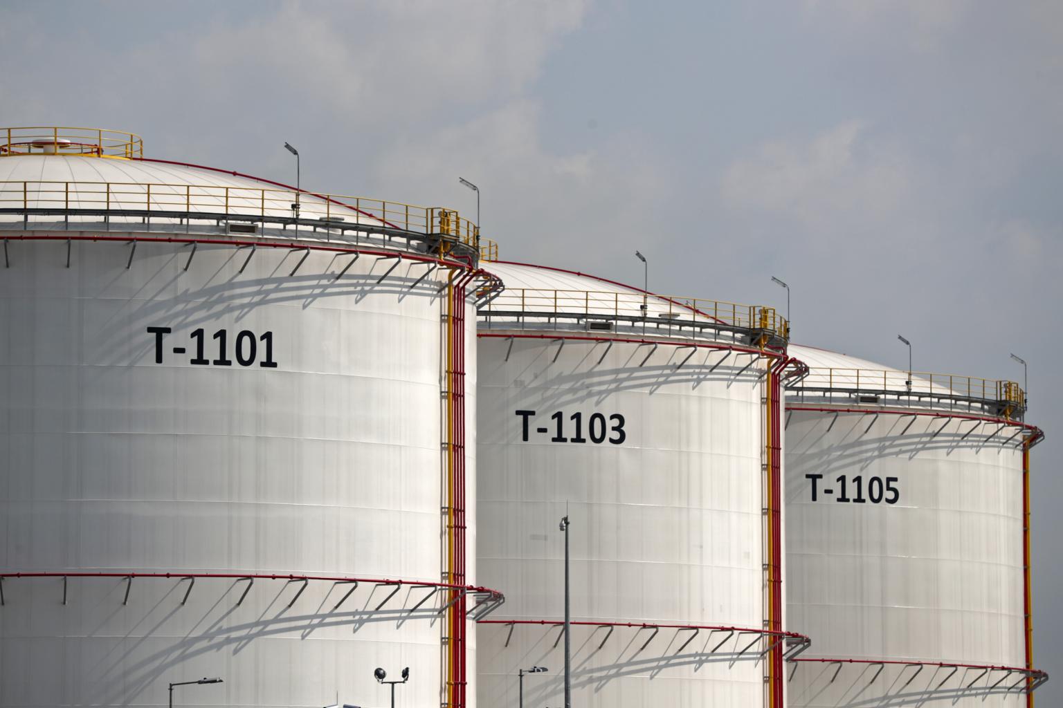 Numbered white bulk storage tanks T-1101, T-1103 and T-1105